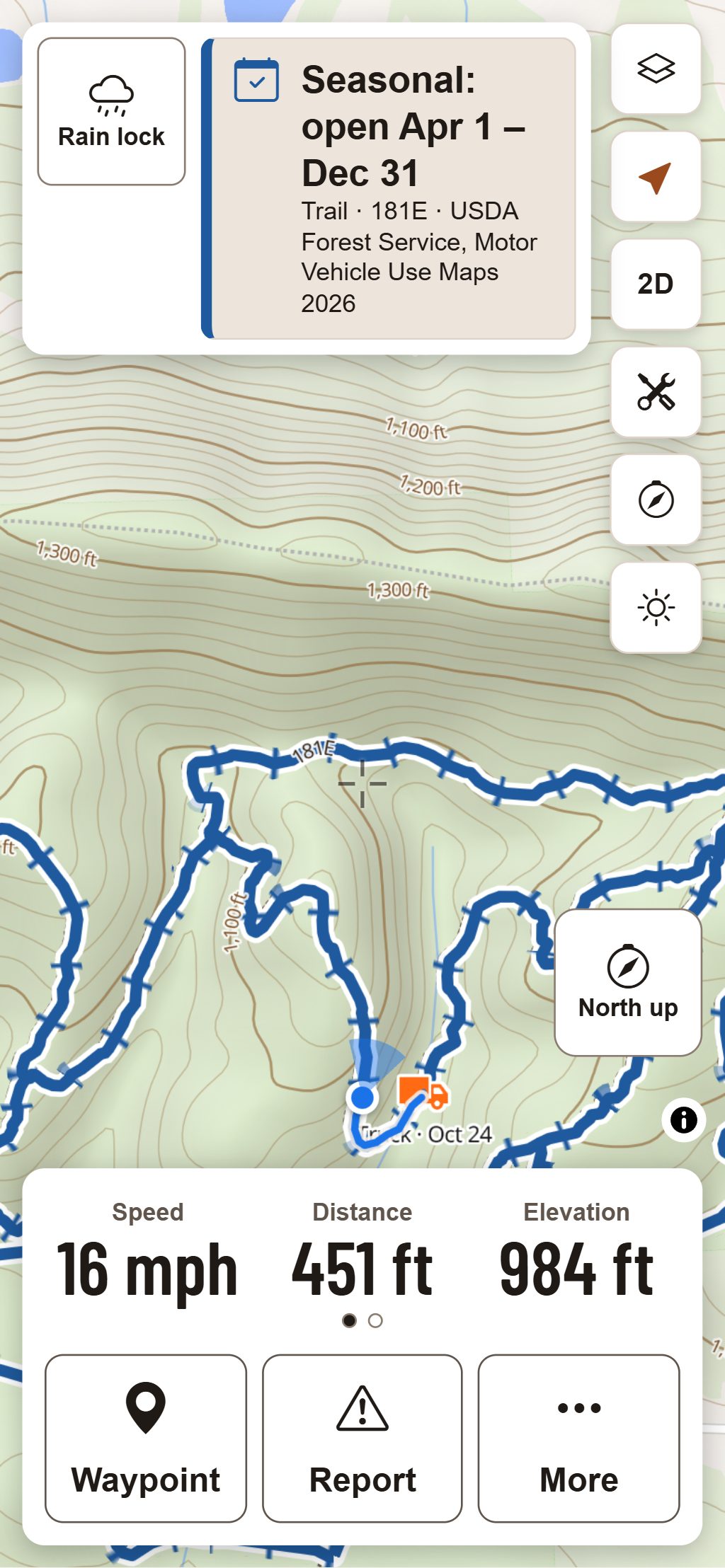 Ride Mode on a phone held upright on the same trail: the band with the trail’s season and source at the top, the map following the rider with the truck marked where the ride started, then the dash and large Waypoint, Report and More buttons at the bottom.