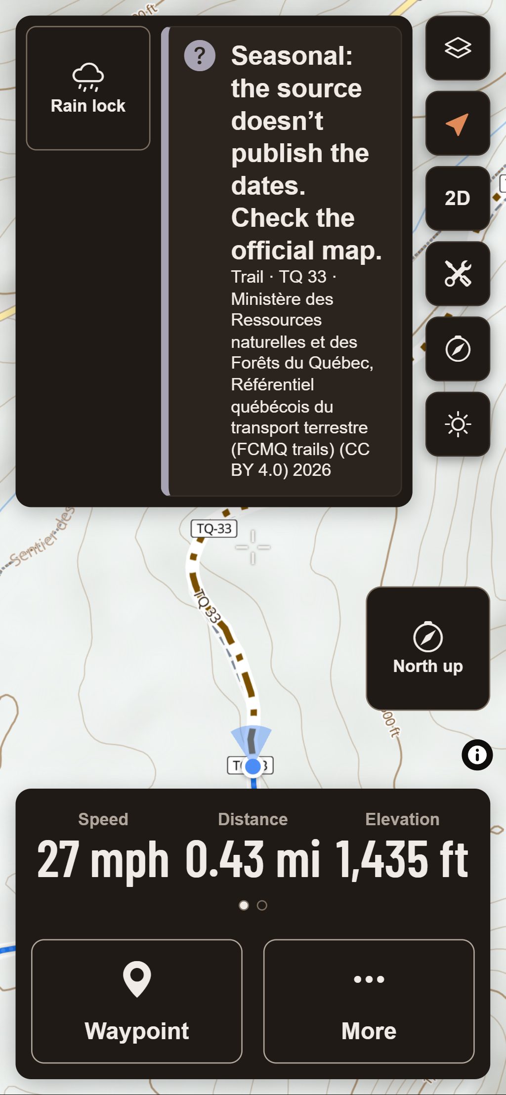 HuntGrid Offroad on a phone in Ride Mode with mitten-size buttons, on a test ride replayed along Trans-Québec trail 33 near Saint-Donat, Quebec: the band at the top says the trail is seasonal and its source doesn’t publish the dates, and names the source; speed, distance and elevation are below.